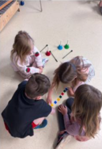Students sitting on the floor playing